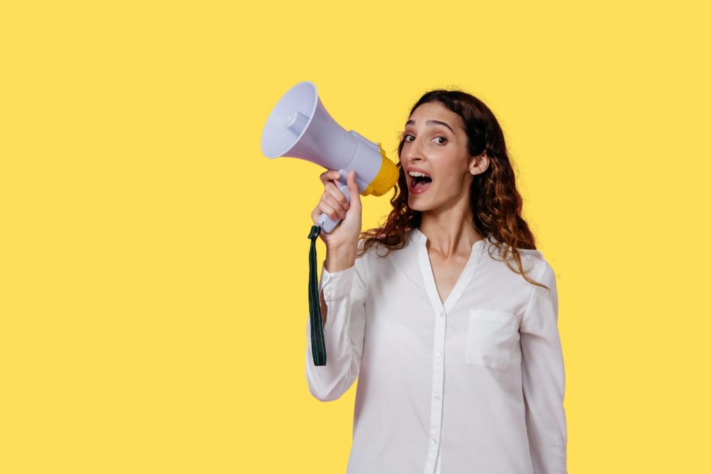 a woman shouting into a megaphone