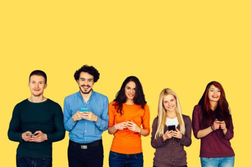 a group of 5 people holding their mobile phones