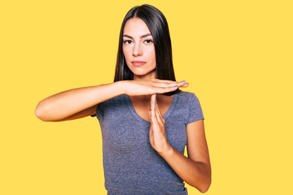 A woman doing the time-out sign with her hands