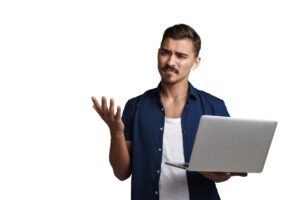 A man holding a laptop and looking confused