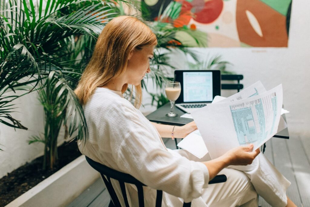 A person at a desk looking at papers in their hand